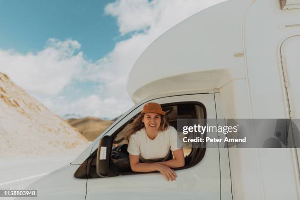 woman leaning out window of motorhome - new zealand people stock pictures, royalty-free photos & images