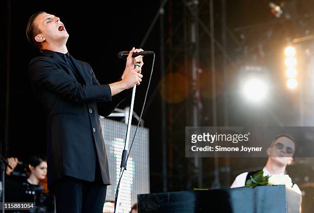 Theo Hutchcraft and Adam Anderson of Hurts perform live on the main stage during day two of the Isle of Wight Festival 2011 at Seaclose Park on June...