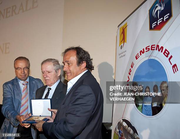 President Michel Platini decorates his father Aldo , on June 11 with a Golden order of the French Football Federation during a general assembly of...