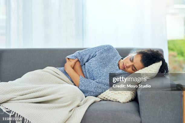 i need painkiller and a hot water bottle - menstruation stock pictures, royalty-free photos & images