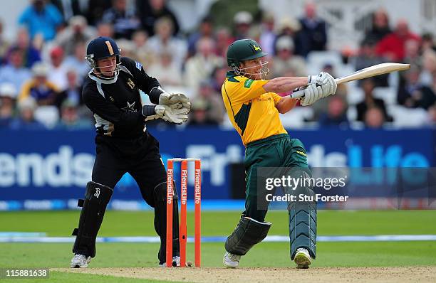 Nottinghamshire batsman Chris Read hits out watched by wicketkeeper Tim Ambrose during the Friends Life T20 match between Nottinghamshire and...