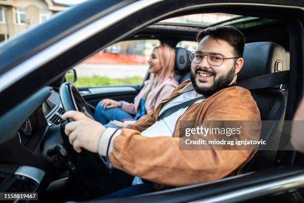 multi-ethnic people driving in car - ethnic woman driving a car stock pictures, royalty-free photos & images