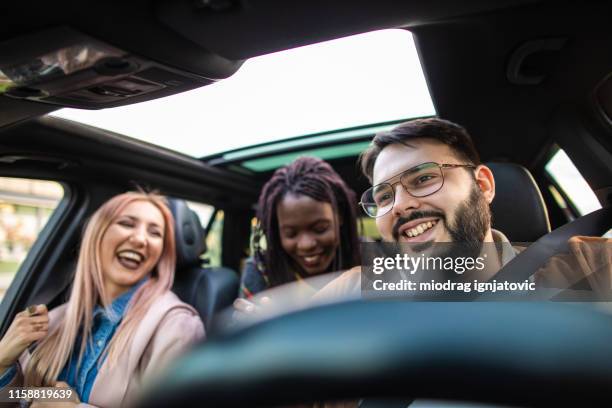 multi-ethnic people driving in car - ethnic woman driving a car stock pictures, royalty-free photos & images