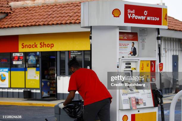 An employee empties trash cans at a Royal Dutch Shell Plc gas station in Redondo Beach, California, U.S., on Sunday, July 28, 2019. Royal Dutch Shell...