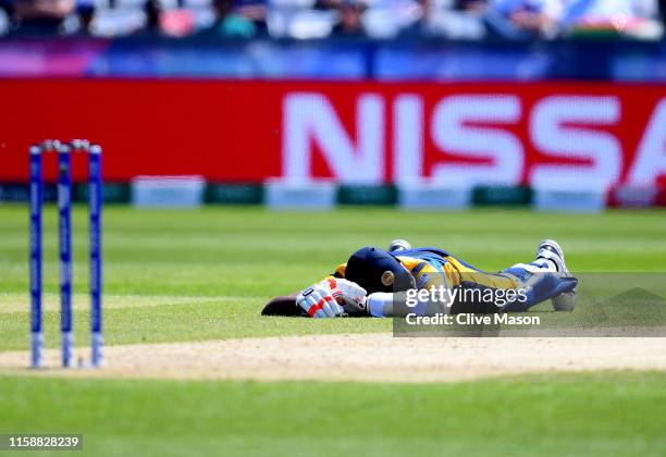 Suranga Lakmal of Sri Lanka lays down to avoid a swarm of bees during the Group Stage match of the ICC Cricket World Cup 2019 between Sri Lanka and...