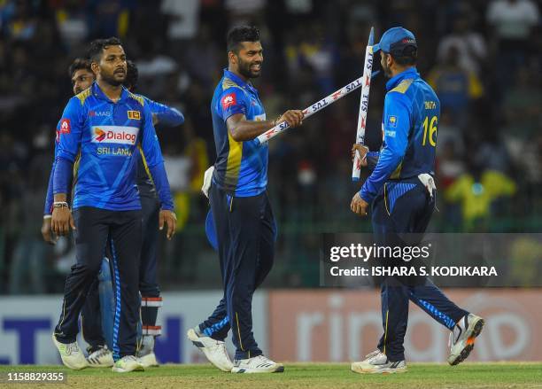 Sri Lankan captain Dimuth Karunaratne and teammate Lahiru Kumara celebrate after their team's victory over Bangladesh by 122 runs in the third one...