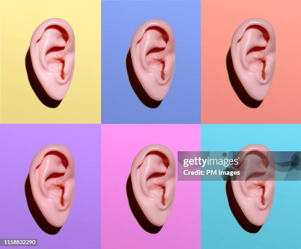 human ears on different colors - lawaai stockfoto's en -beelden