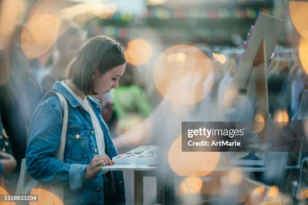 young girl shopping in a  flea market for jewellery in summer, zero waste concept - flea market stock pictures, royalty-free photos & images