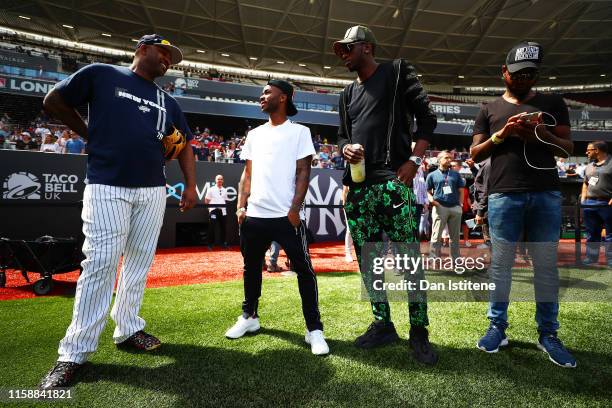 Raheem Sterling of England and Manchester City speaks with CC Sabathia of the New York Yankees on the field during previews ahead of the MLB London...