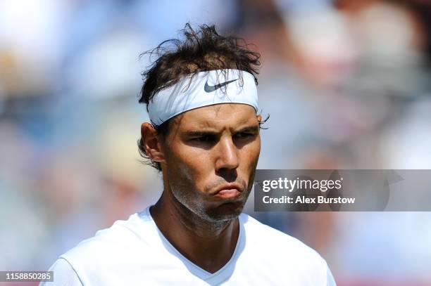 Rafael Nadal of Spain reacts during his men's singles exhibition match against Lucas Pouille of France during the Aspall Tennis Classic at the...