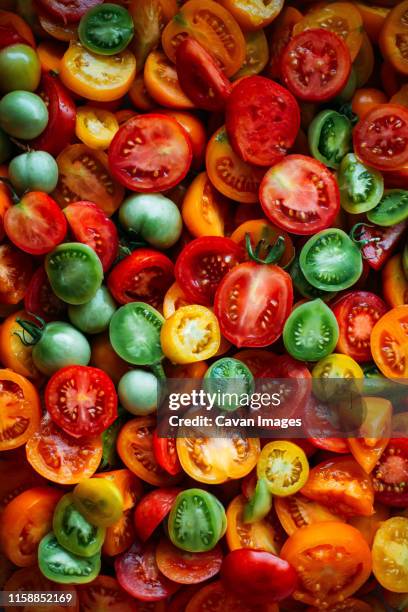 overhead view of fresh red tomatoes on table - beefsteak tomato stock pictures, royalty-free photos & images