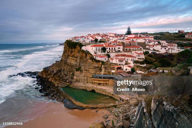typical village on the seaside cliff at sunset. amazing seascape near lisbon. coastal landscape and tourist attraction of portugal. sintra natural park. - azenhas do mar stock pictures, royalty-free photos & images