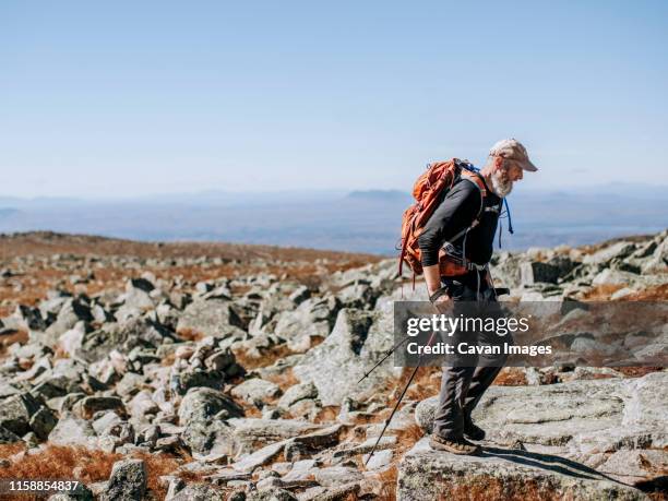 a male retirement age hiker approaches the top of mount katahdin - hiking appalachian trail stock pictures, royalty-free photos & images