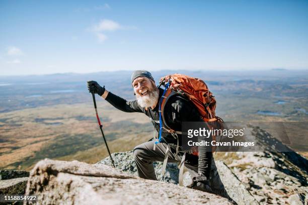 a retired male hiker struggles as he climbs mount katahdin in maine - hiking appalachian trail stock pictures, royalty-free photos & images