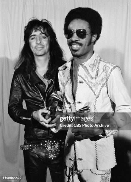 Alice Cooper, presenter, and Stevie Wonder, Grammy winner for Album of The Year, "Innervisions," pose back stage at the 16th Annual Grammy Awards,...
