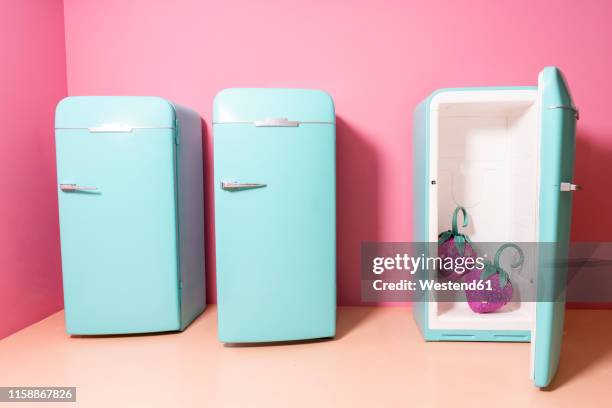 two oversized strawberries in fridge at an indoor theme park - funny fridge stock pictures, royalty-free photos & images