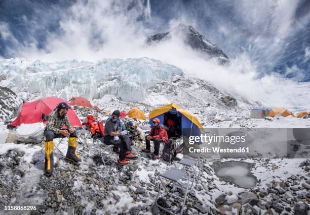 nepal, solo khumbu, everest, western cwm, mountaineers sitting in camp - young men camping stock pictures, royalty-free photos & images