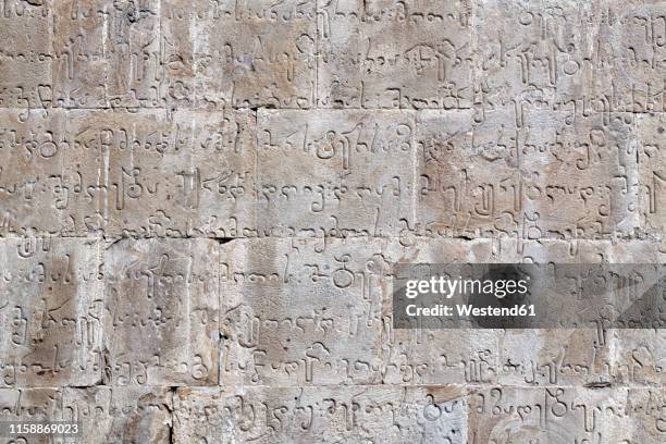 georgia, gudauri, sanskrit writing on stone wall - ボンゴ ストックフォトと画像