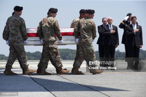 Vice President Mike Pence and Acting Secretary of Defense Mark Esper stand at attention as members of the a U.S. Army carry team move the flag-draped...