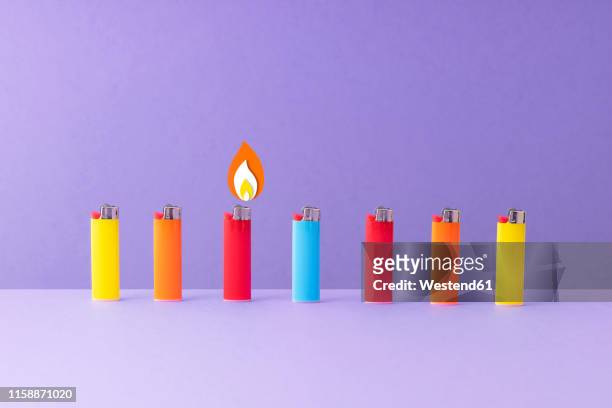 ilustraciones, imágenes clip art, dibujos animados e iconos de stock de row of colorful lighters against purple background - lighter