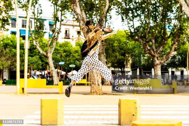 girl jumping from bollard to bollard - bollards stock pictures, royalty-free photos & images