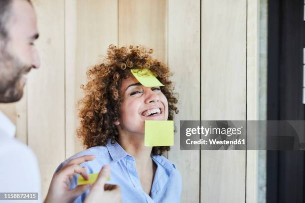 colleagues in office brainstorming and fooling around with post-its - sticky stock pictures, royalty-free photos & images
