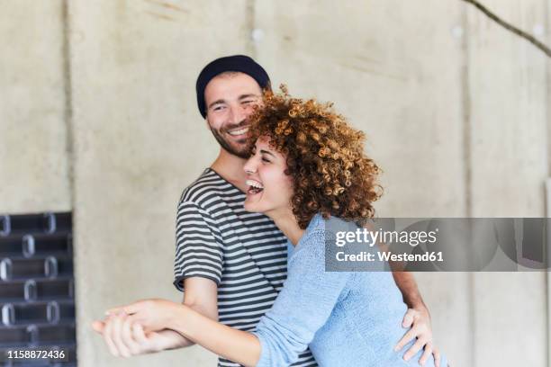 laughing playful couple dancing - men laughing stock-fotos und bilder