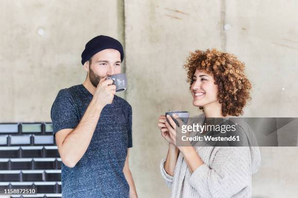 man and woman drinking coffee together - office coffee break stock pictures, royalty-free photos & images