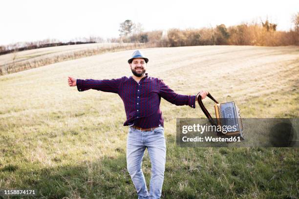 bearded man with accordion dancing on a meadow - accordionist - fotografias e filmes do acervo