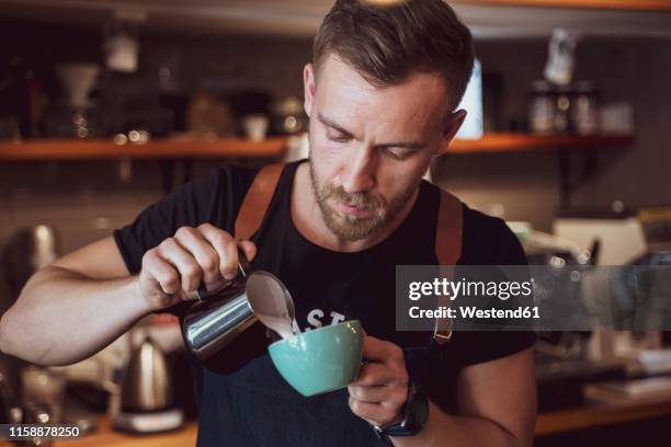 barista preparing a coffee in coffee shop - barista stock pictures, royalty-free photos & images