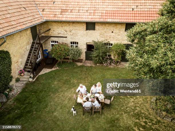 family eating together in the garden in summer - garden aerial view stock pictures, royalty-free photos & images