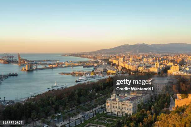 spain, malaga, view over the harbour and the townhall by sunrise - alcazaba of málaga stock pictures, royalty-free photos & images