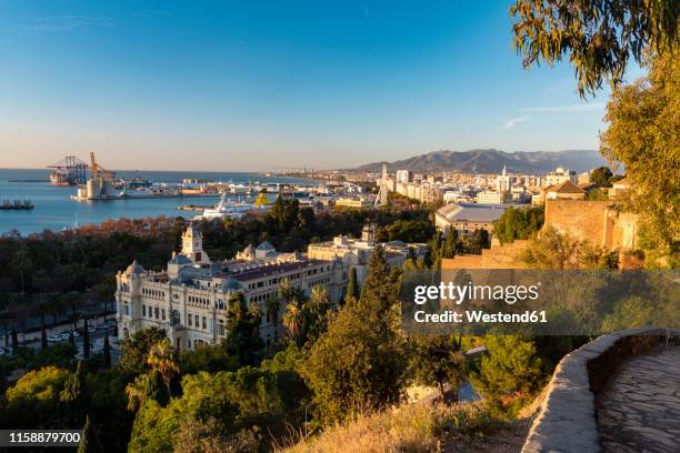 spain, malaga, view over the harbour and the townhall by sunrise - alcazaba of málaga stock pictures, royalty-free photos & images