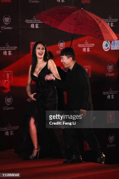 Actress Maria Grazia Cucinotta and actor Huang Bo arrive at the opening ceremony of the 14th Shanghai International Film Festival on June 11, 2011 in...