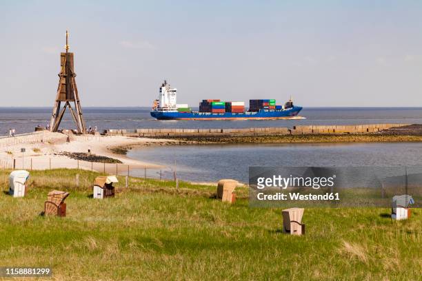 germany, lower saxony, cuxhaven, north sea, ball beacon at beach, hooded beach chairs, container ship - cuxhaven stock-fotos und bilder