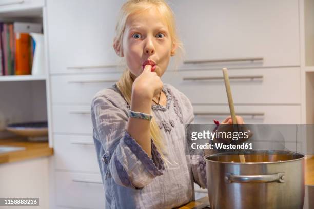 portrait of girl cooking jam at home - träsked bildbanksfoton och bilder