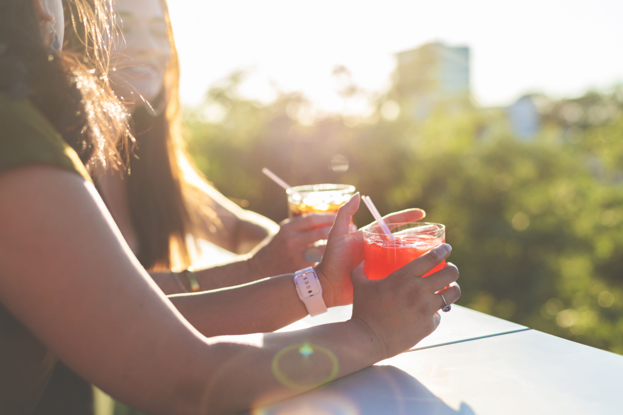 Attractive Vibrant Females At Sunset Enjoying and An Urban Environment with Cocktails Attractive Vibrant Females At Sunset Enjoying and An Urban Environment with Cocktails
