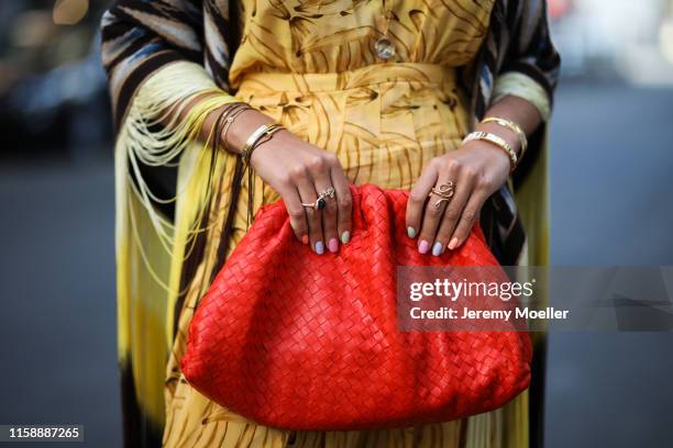 Nina Suess wearing Adriana Degreas dress, Antonia Zander poncho, Bottega Veneta bag and Cartier jewelry on June 28, 2019 in Berlin, Germany.