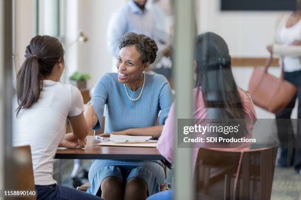 bank advisor shakes applicants hand - credit union stock pictures, royalty-free photos & images