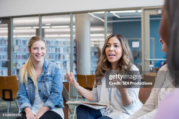 mid adult committee leader gestures as she explains the plans - vulnerability management stock pictures, royalty-free photos & images
