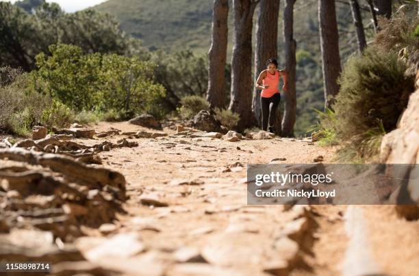 running on a rocky trail - uphill stock pictures, royalty-free photos & images