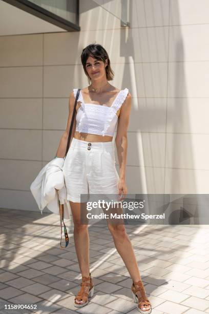 Guest is seen on the street attending 080 Barcelona Fashion Week wearing white crop top, white shorts and brown sandals on June 28, 2019 in...