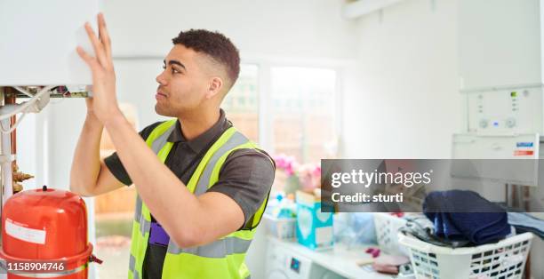 young heating engineer - home repair stock pictures, royalty-free photos & images