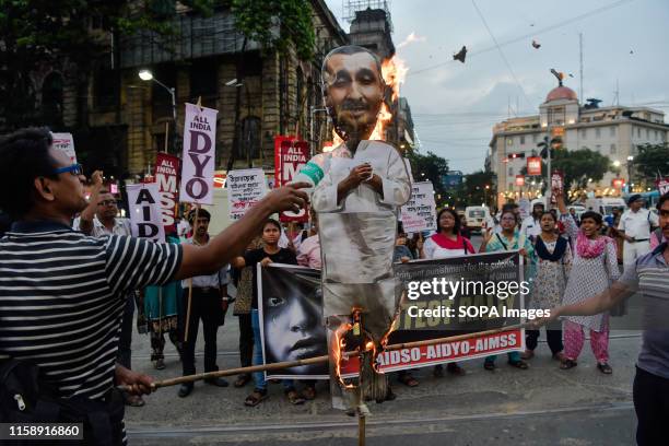 Protesters burn an effigy depicting kuldeep singh senegar a legislator of Bharatiya Janata Party during a protest demanding for justice on a rape...