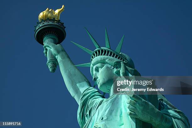 a closeup, upward pointing view of the statue of liberty - statue of liberty new york city stock pictures, royalty-free photos & images