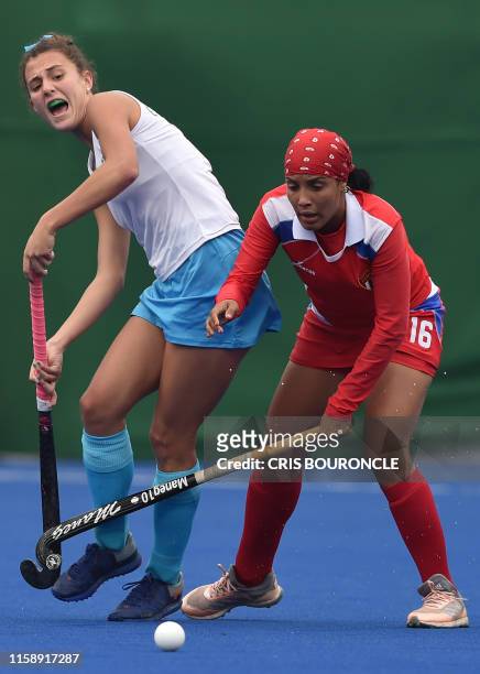 Uruguay's Constanza Barrandeguy and Cuba's Jessica Ortiz battle for the ball during a Pan-American Games Lima 2019 field hockey match in Lima, on...