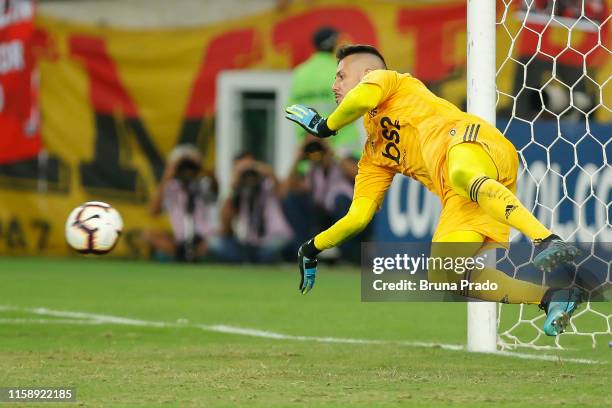 Goalkeeper Diego Alves of Flamengo saves a penalty during a shootout after a round of sixteen second leg match between Flamengo and Emelec as part of...