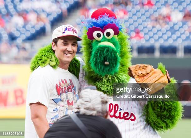 Actor Miles Teller and the Phillie Phanatic pose at the San Francisco Giants vs Philadelphia Phillies game at Citizens Bank Park on July 31, 2019 in...
