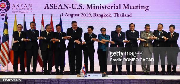 Secretary of State Mike Pompeo poses for a family photo with Philippines' Foreign Minister Teodoro Locsin Jr, Singapore's Foreign Minister Vivian...