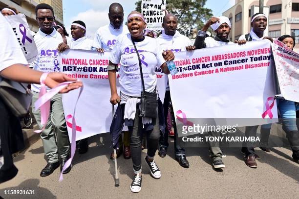 Cancer patient, Miriam Shikami suffering from cancer for the past year, marches alongside other patients and activists in protest August 01, 2019 in...